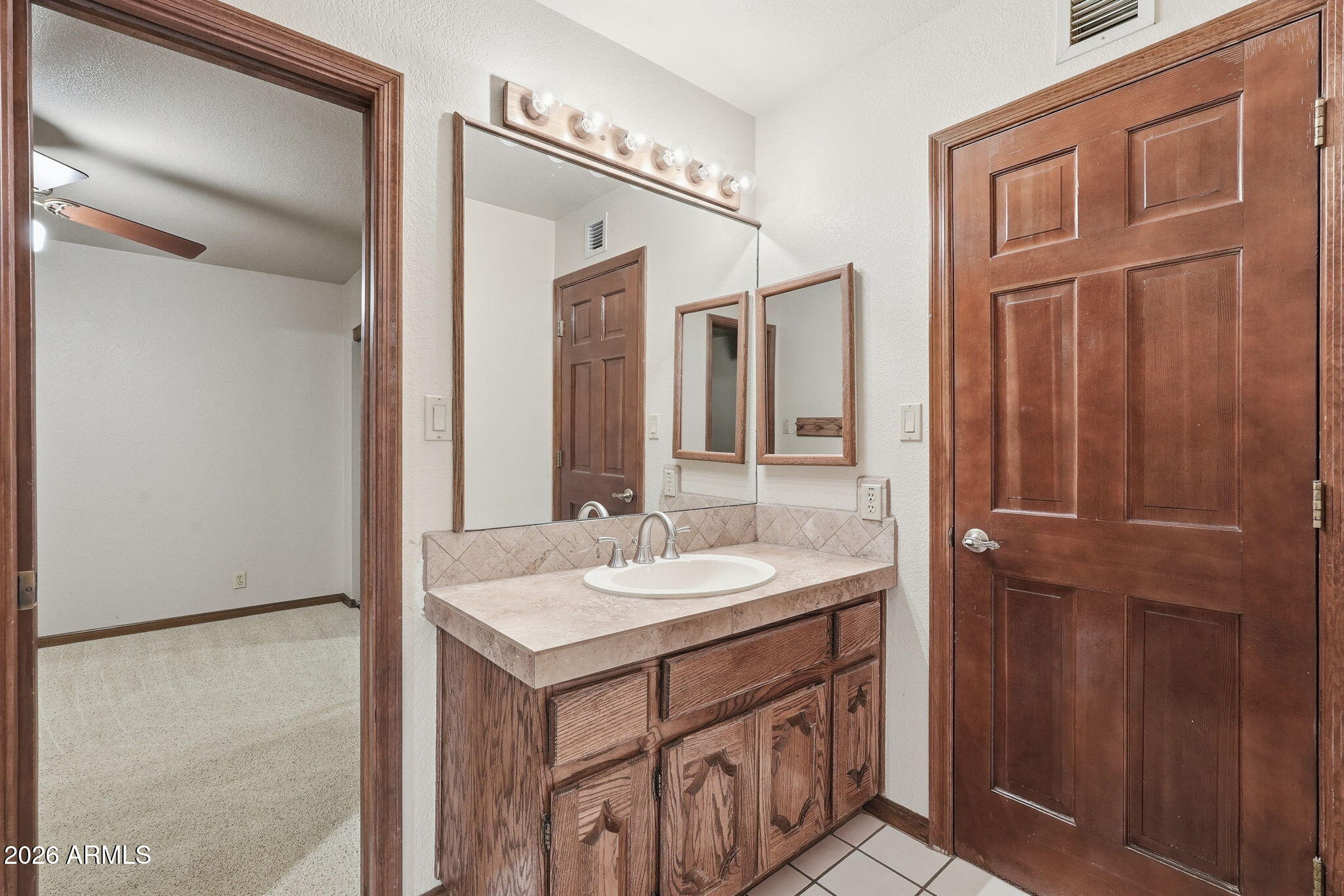602 East Carver Road Tempe, AZ 85284 - Photo 47 of 85 a bathroom with a sink a vanity and a mirror