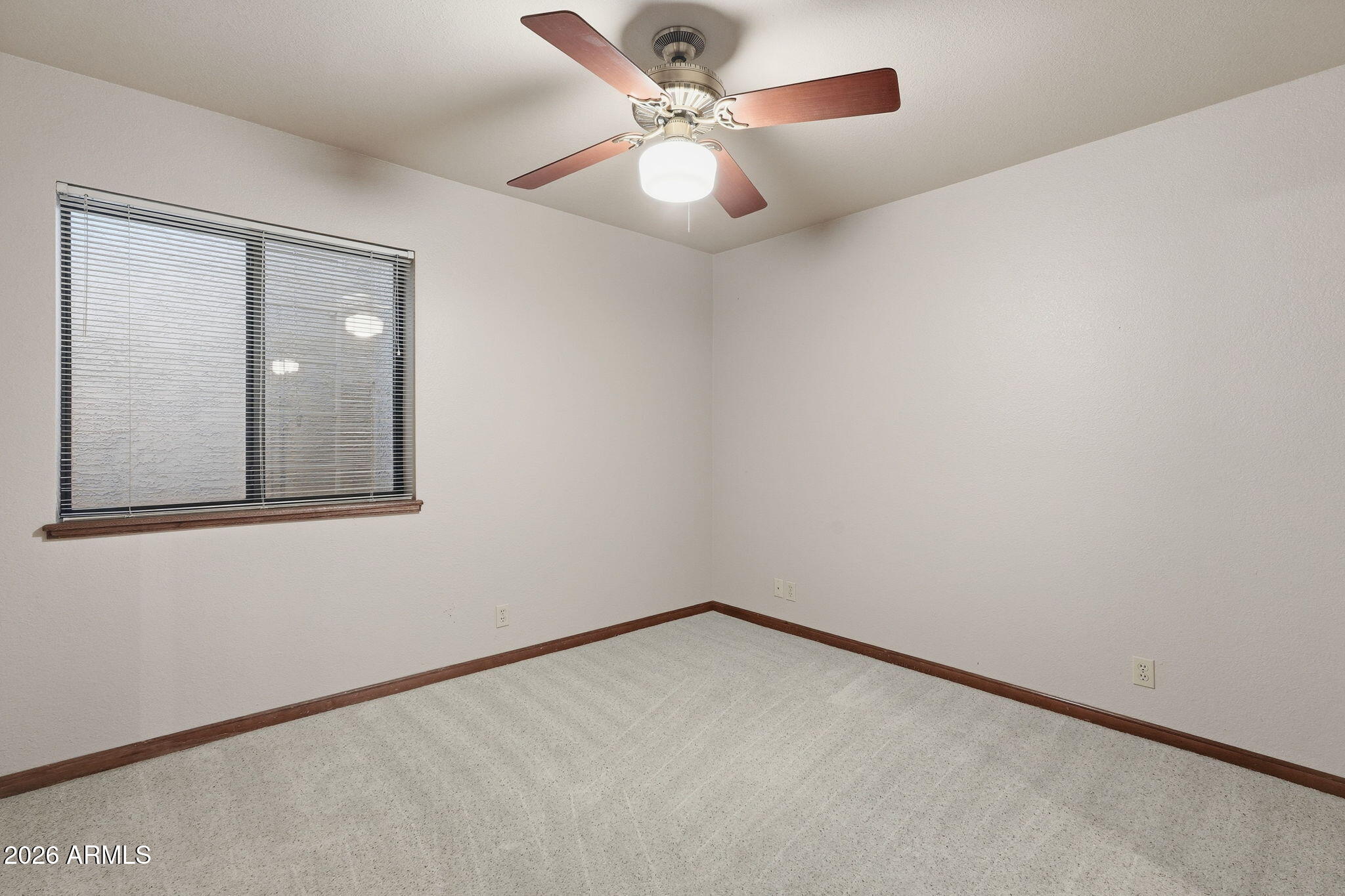 602 East Carver Road Tempe, AZ 85284 - Photo 49 of 85 an empty room with a chandelier fan and windows