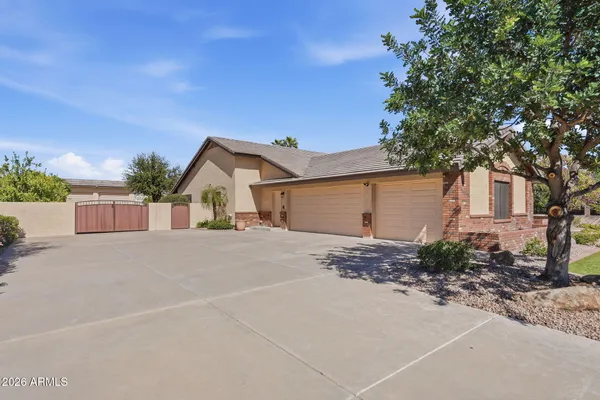 a view of a house with a yard and garage