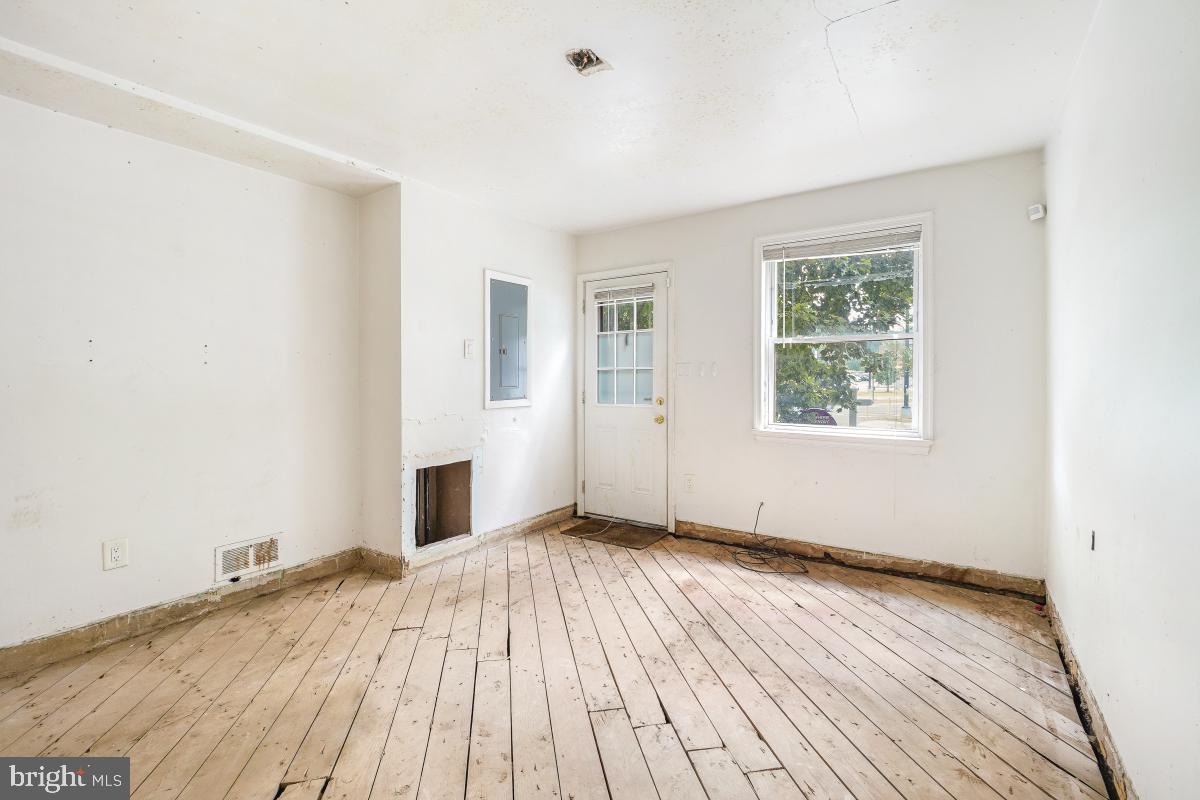 1280 16th Street Northeast Washington, DC 20002 - Photo 16 of 33 an empty room with wooden floor and windows