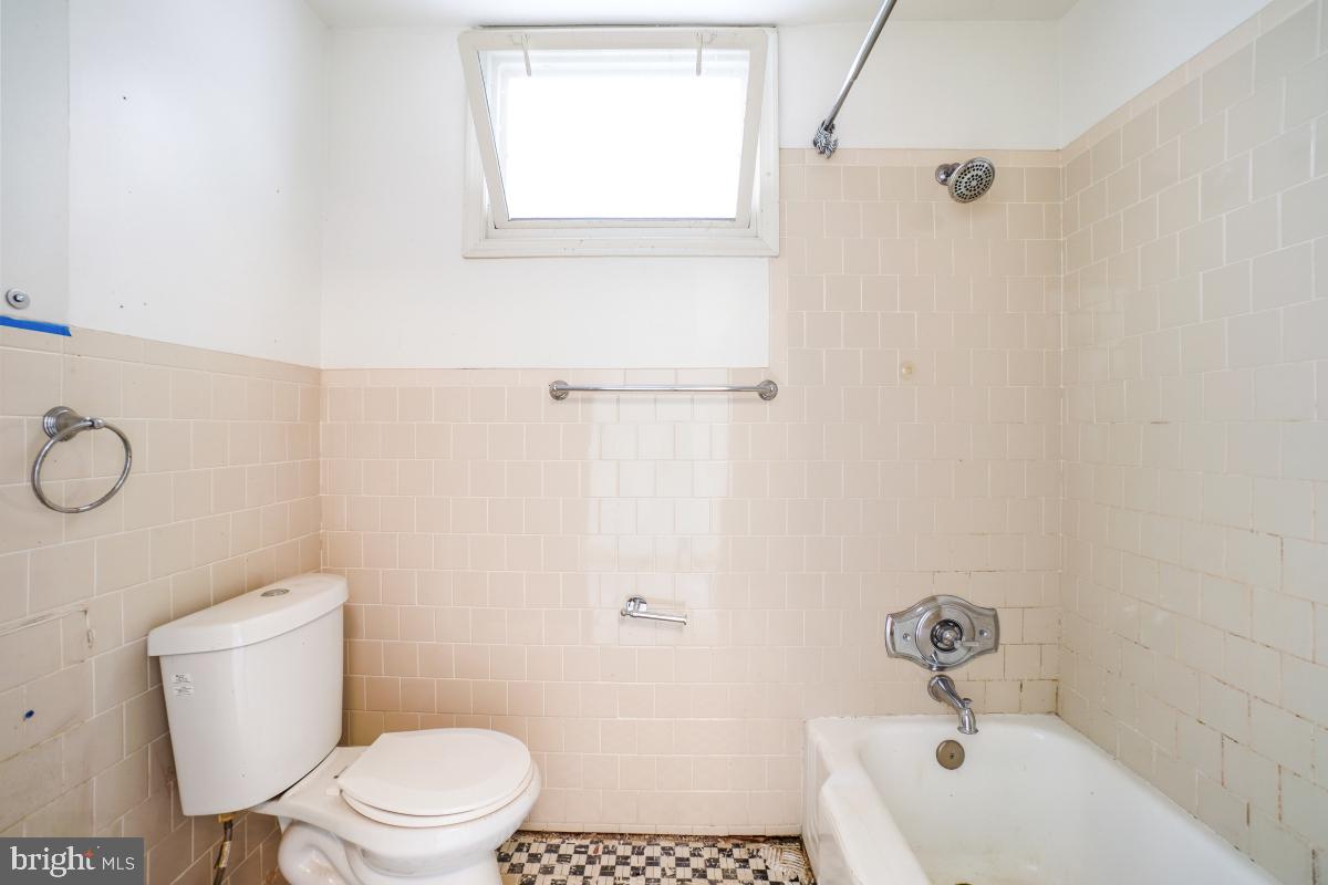 1280 16th Street Northeast Washington, DC 20002 - Photo 19 of 33 a white toilet sitting next to a white tub