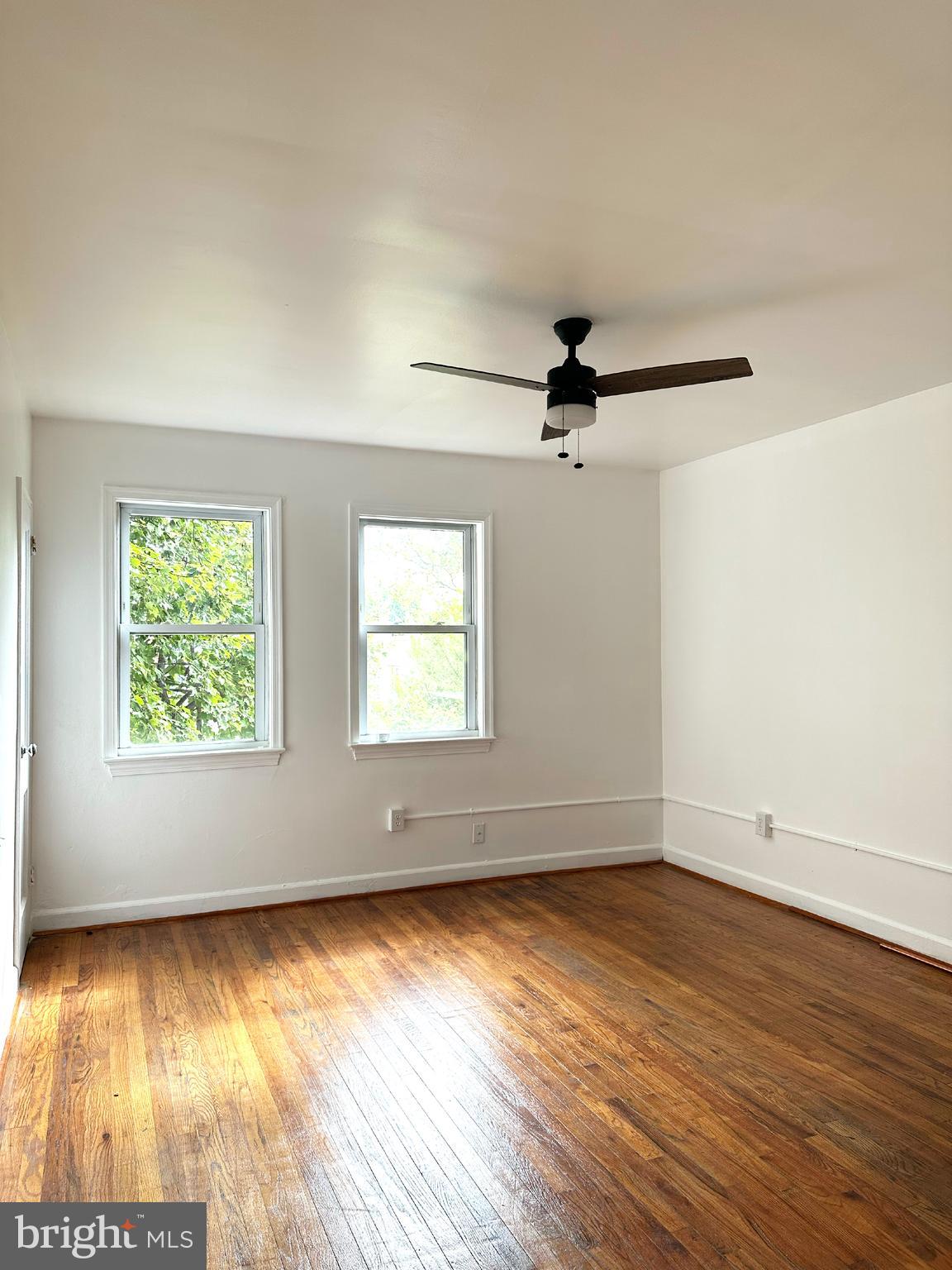 1280 16th Street Northeast Washington, DC 20002 - Photo 3 of 33 an empty room with wooden floor fan and windows
