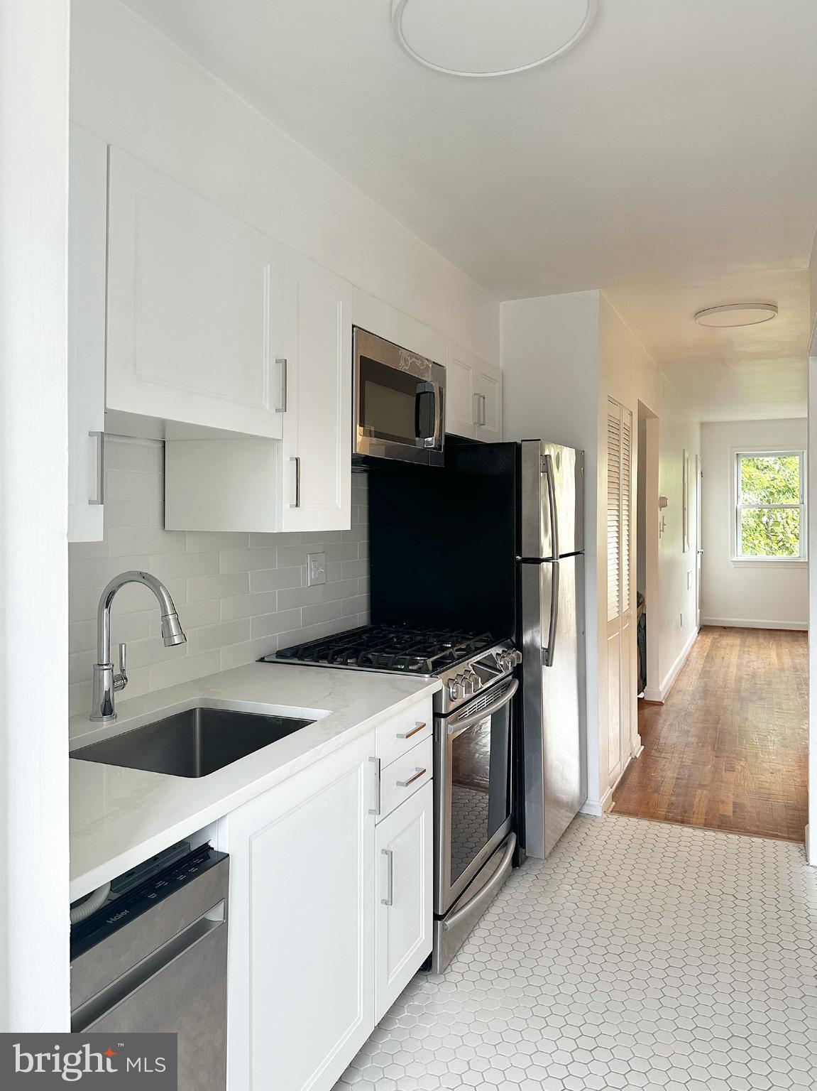 1280 16th Street Northeast Washington, DC 20002 - Photo 4 of 33 a kitchen with stainless steel appliances a stove microwave and sink