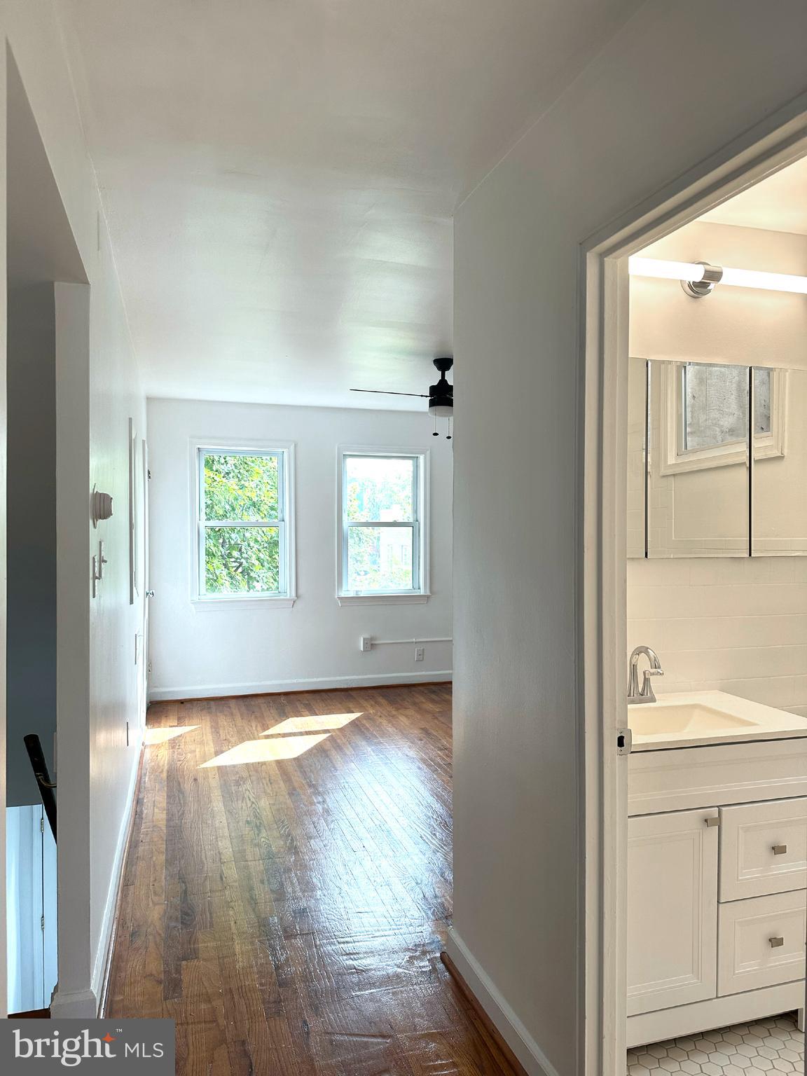 1280 16th Street Northeast Washington, DC 20002 - Photo 8 of 33 a view of a hallway with wooden floor and cabinet