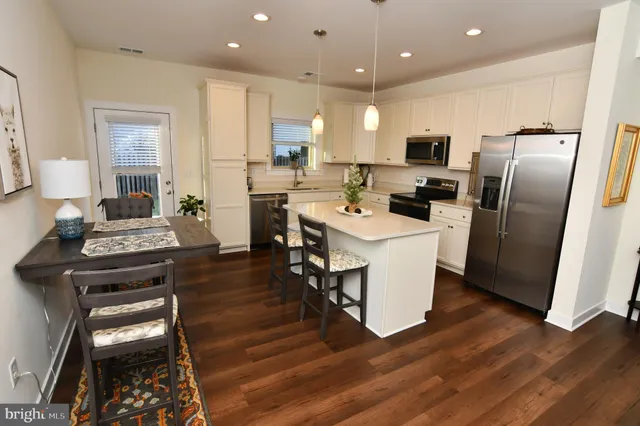 a kitchen with sink a stove and cabinets