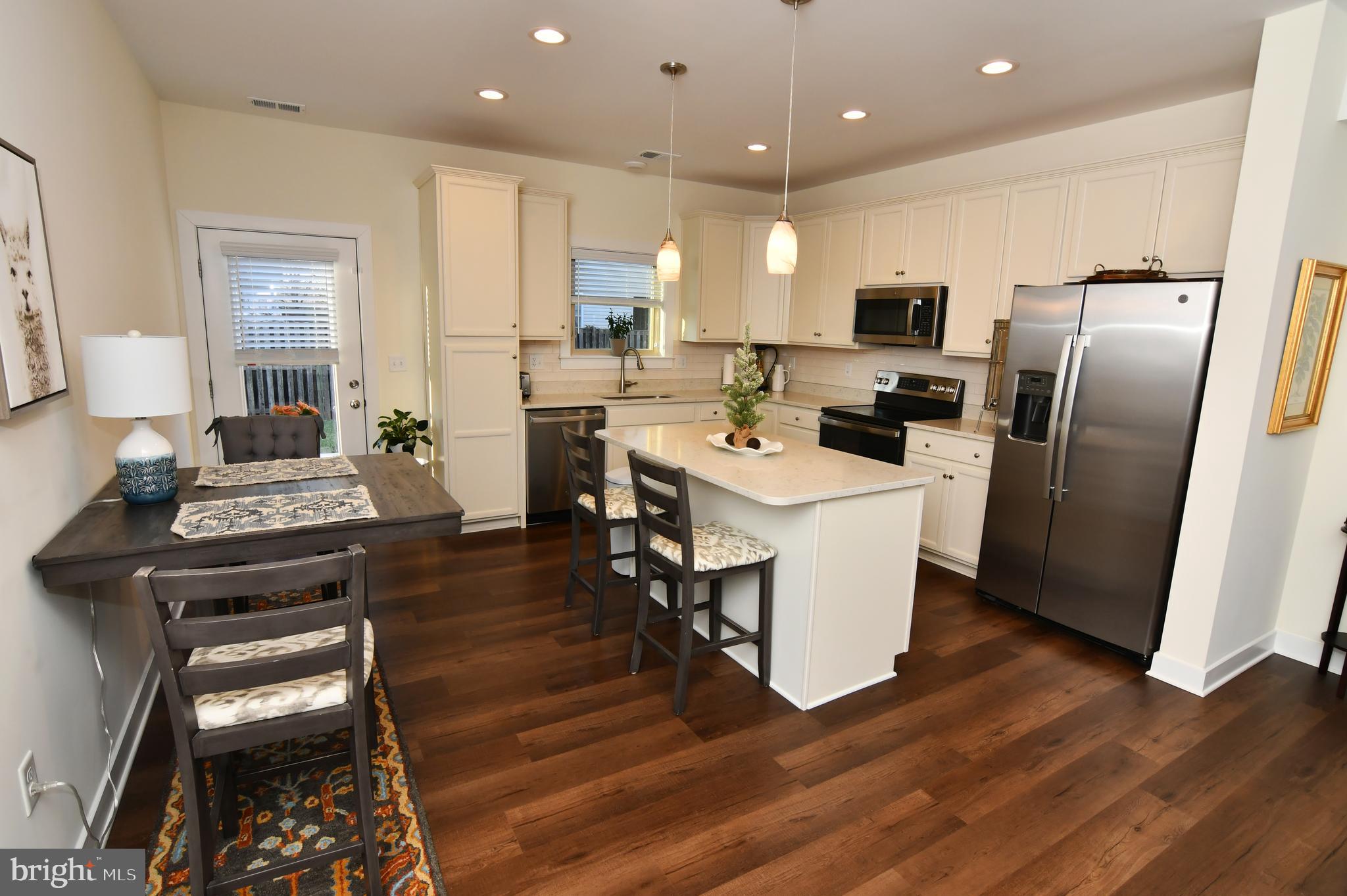 129 Doonbeg Court Winchester, VA 22602 - Photo 13 of 51 a kitchen with a refrigerator a stove top oven a sink dishwasher and white cabinets with wooden floor