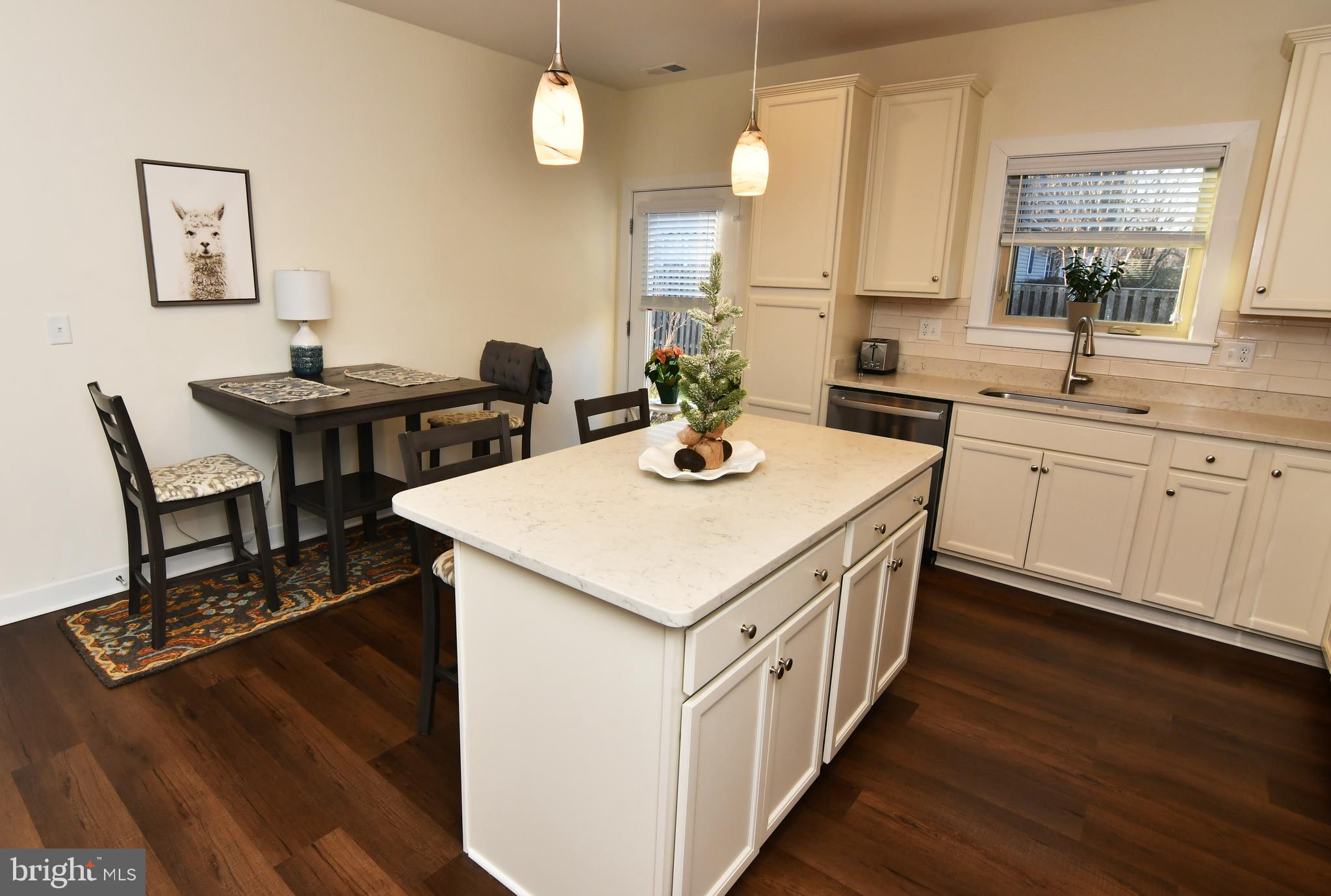 129 Doonbeg Court Winchester, VA 22602 - Photo 15 of 51 a kitchen that has a table chairs in it and wooden floors
