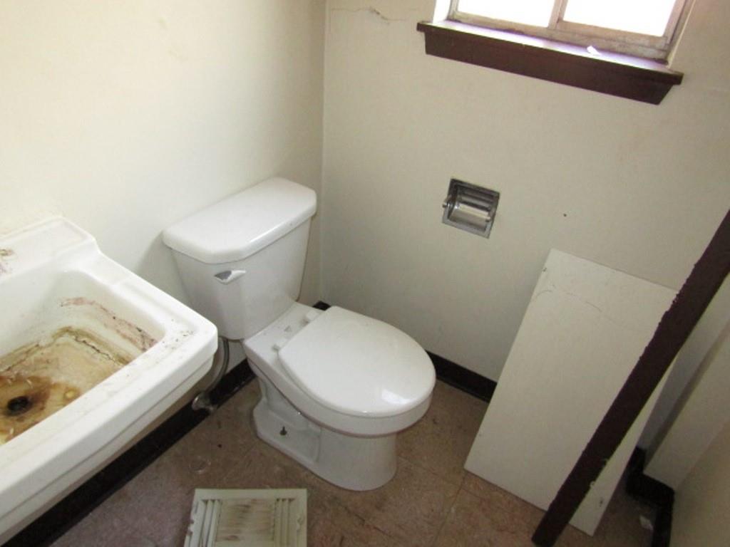 606 Middle Street Pittsburgh, PA 15212 - Photo 14 of 39 a white toilet sitting next to a white sink and vanity