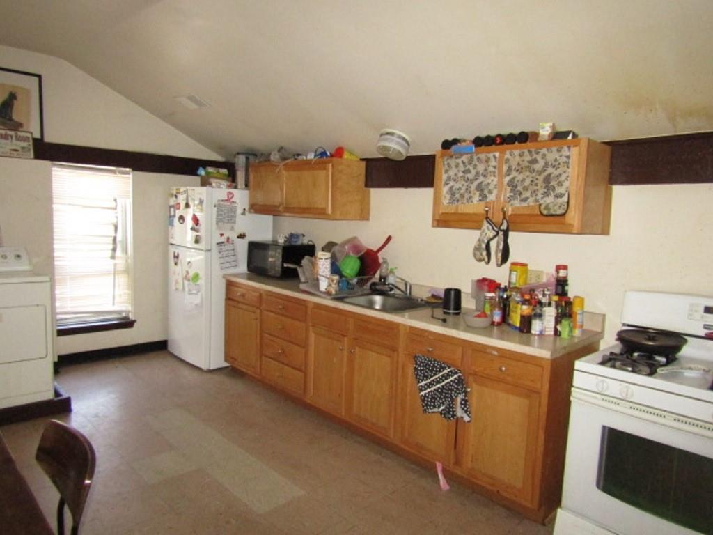 606 Middle Street Pittsburgh, PA 15212 - Photo 19 of 39 a kitchen with stainless steel appliances a stove a sink cabinets and a window