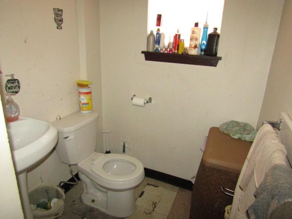 606 Middle Street Pittsburgh, PA 15212 - Photo 23 of 39 a white toilet sitting next to a white sink and a mirror