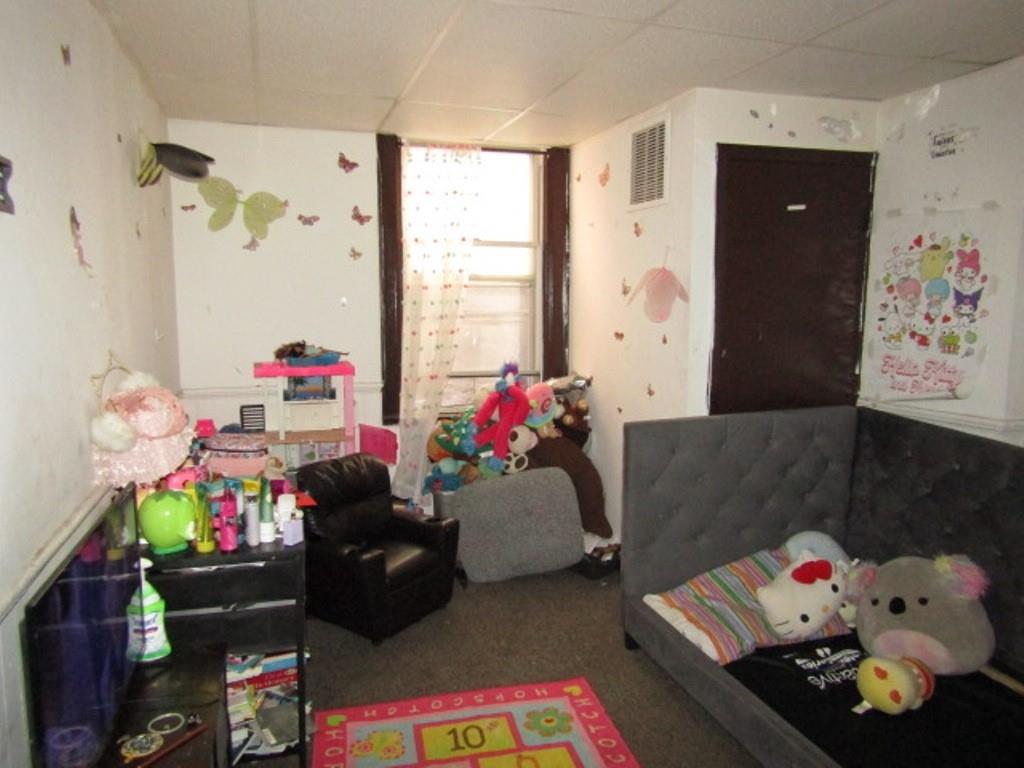606 Middle Street Pittsburgh, PA 15212 - Photo 24 of 39 a bedroom with furniture and a window