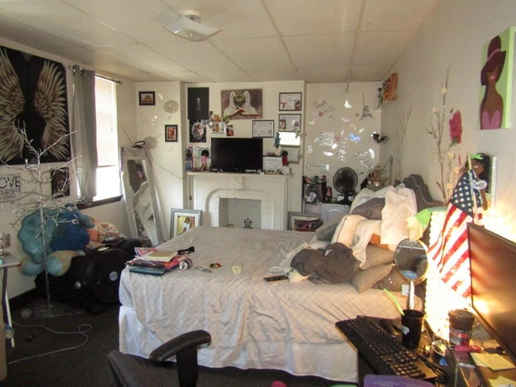 606 Middle Street Pittsburgh, PA 15212 - Photo 29 of 39 a living room with furniture a flat screen tv and a fireplace
