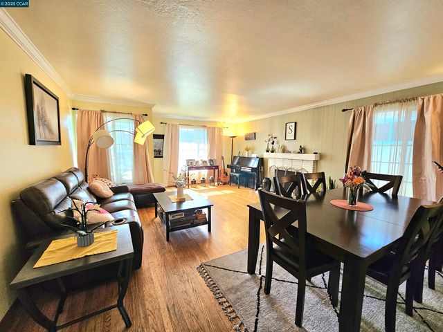 a dining room with furniture and wooden floor