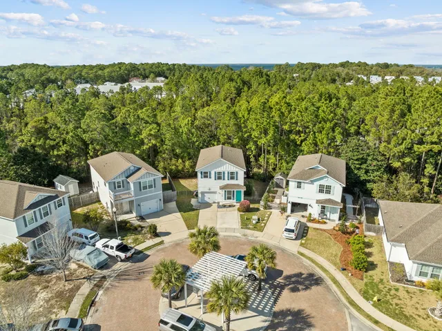 an aerial view of a house with a garden and lake view