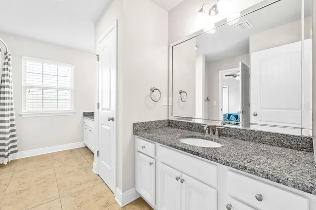 a bathroom with a granite countertop sink a mirror and a