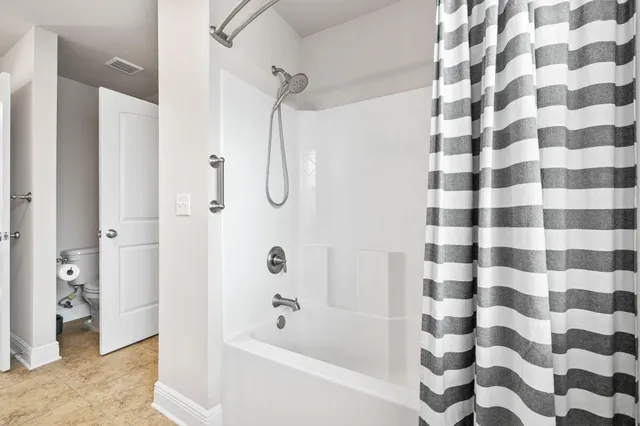 a bathroom with a bathtub and a shower