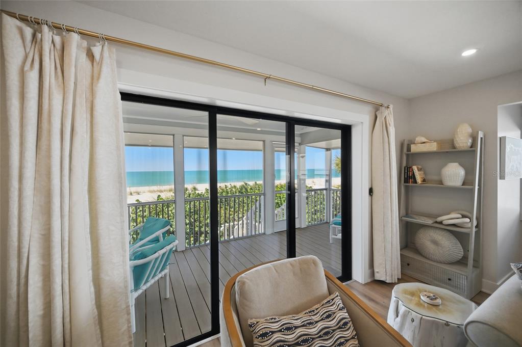 380 Gulf Boulevard, Unit 1 Boca Grande, FL 33921 - Photo 12 of 35 a living room with furniture and a floor to ceiling window
