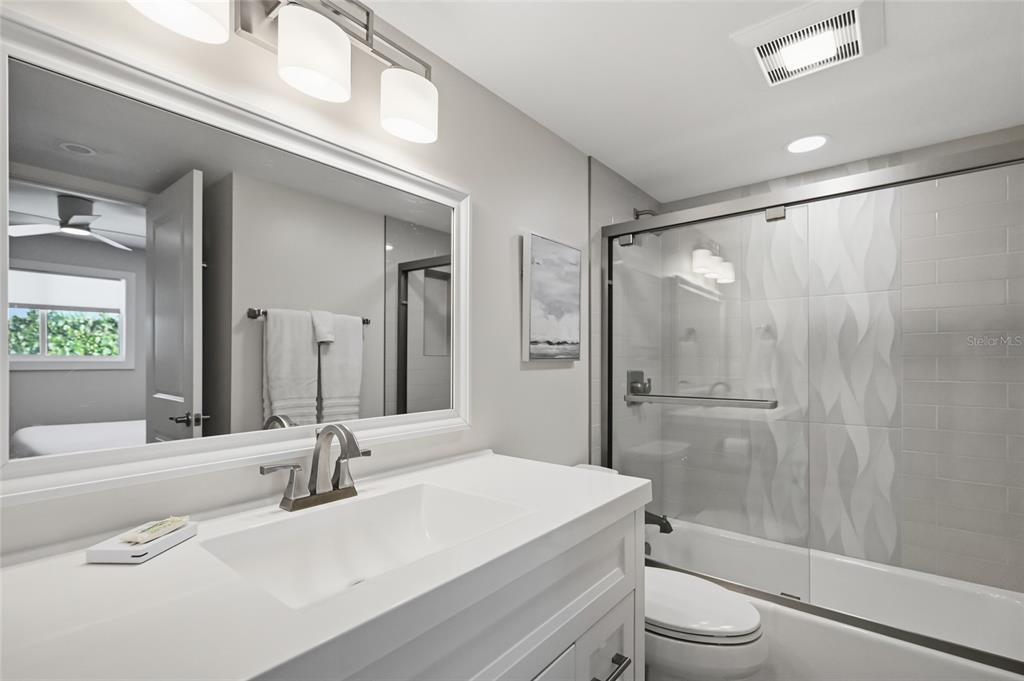 380 Gulf Boulevard, Unit 1 Boca Grande, FL 33921 - Photo 15 of 35 a bathroom with a granite countertop sink toilet and shower