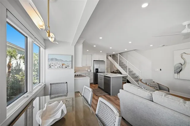a kitchen with cabinets stainless steel appliances and wooden floor