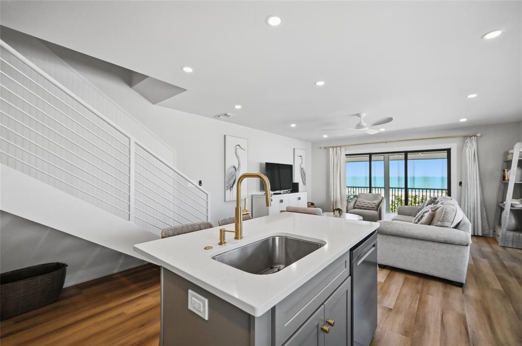 380 Gulf Boulevard, Unit 1 Boca Grande, FL 33921 - Photo 20 of 35 a kitchen with stainless steel appliances granite countertop a sink a stove and a refrigerator