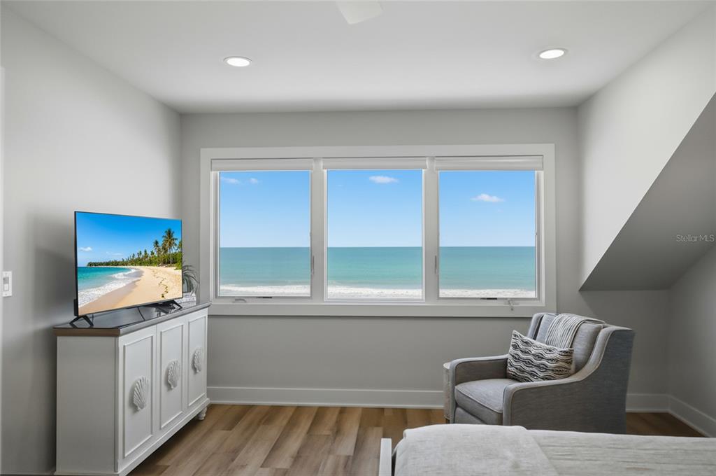 380 Gulf Boulevard, Unit 1 Boca Grande, FL 33921 - Photo 31 of 35 a living room with furniture and a flat screen tv