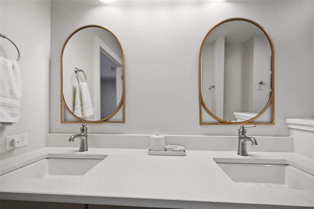 380 Gulf Boulevard, Unit 1 Boca Grande, FL 33921 - Photo 33 of 35 a bathroom with a double vanity sink and a mirror