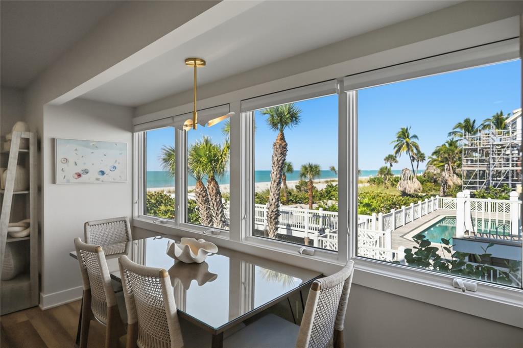 380 Gulf Boulevard, Unit 1 Boca Grande, FL 33921 - Photo 7 of 35 a dining room with furniture a chandelier and wooden floor
