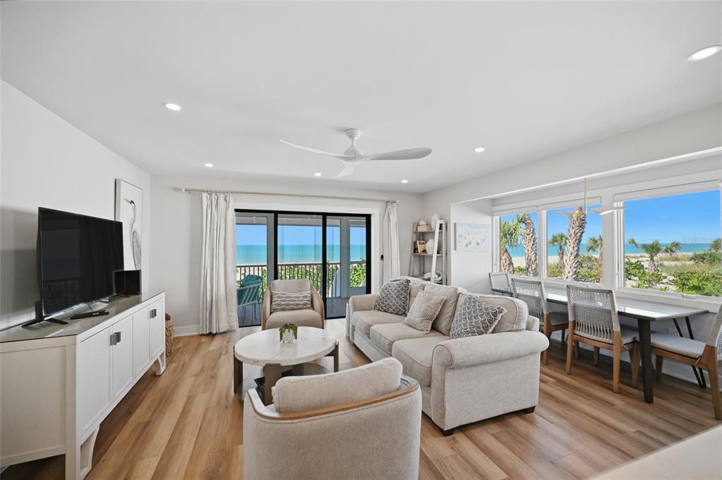 380 Gulf Boulevard, Unit 1 Boca Grande, FL 33921 - Photo 10 of 35 a living room with furniture a flat screen tv and a floor to ceiling window