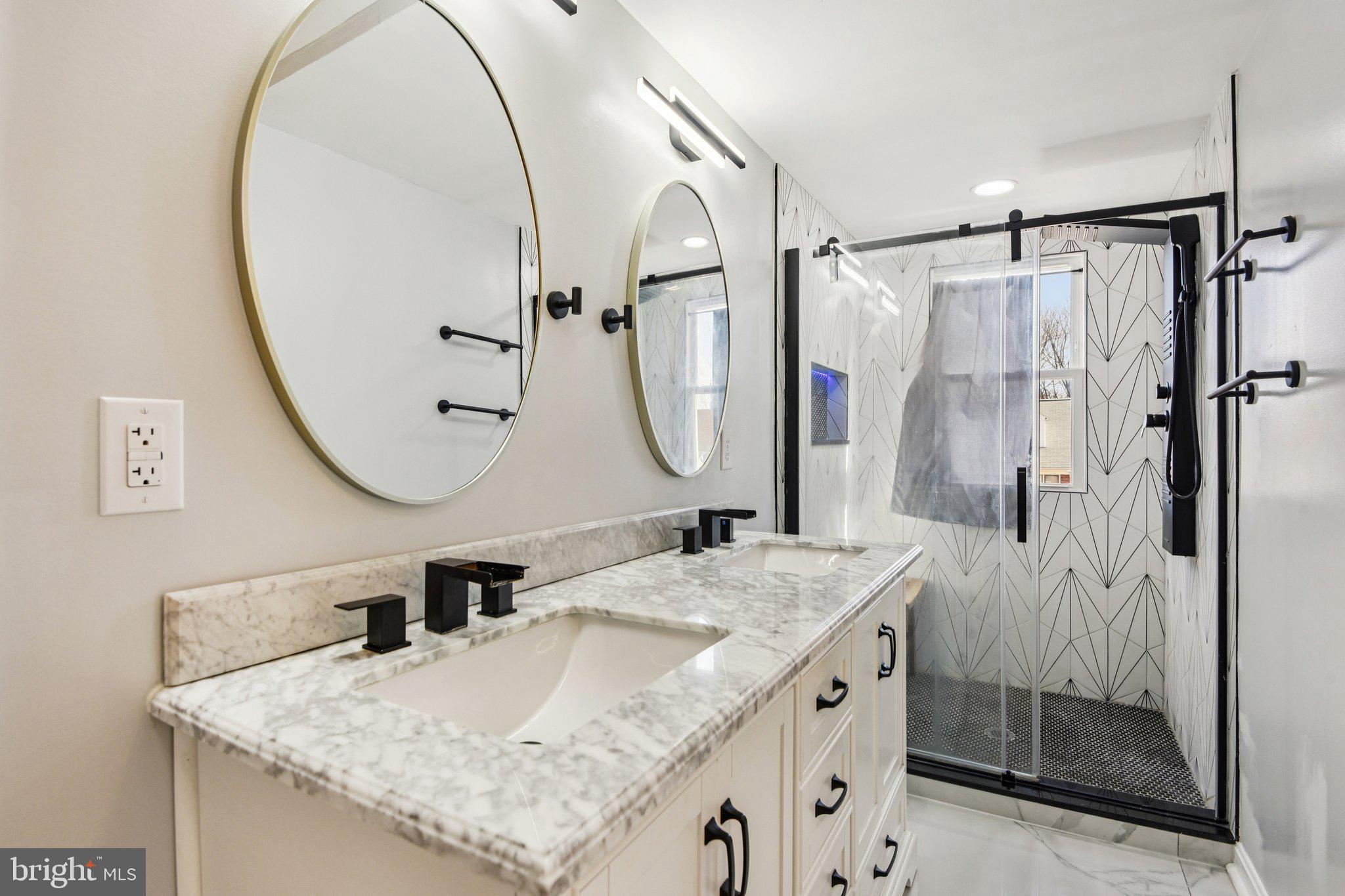 7004 Arion Road Baltimore, MD 21234 - Photo 23 of 43 a bathroom with a granite countertop sink a mirror a vanity and shower