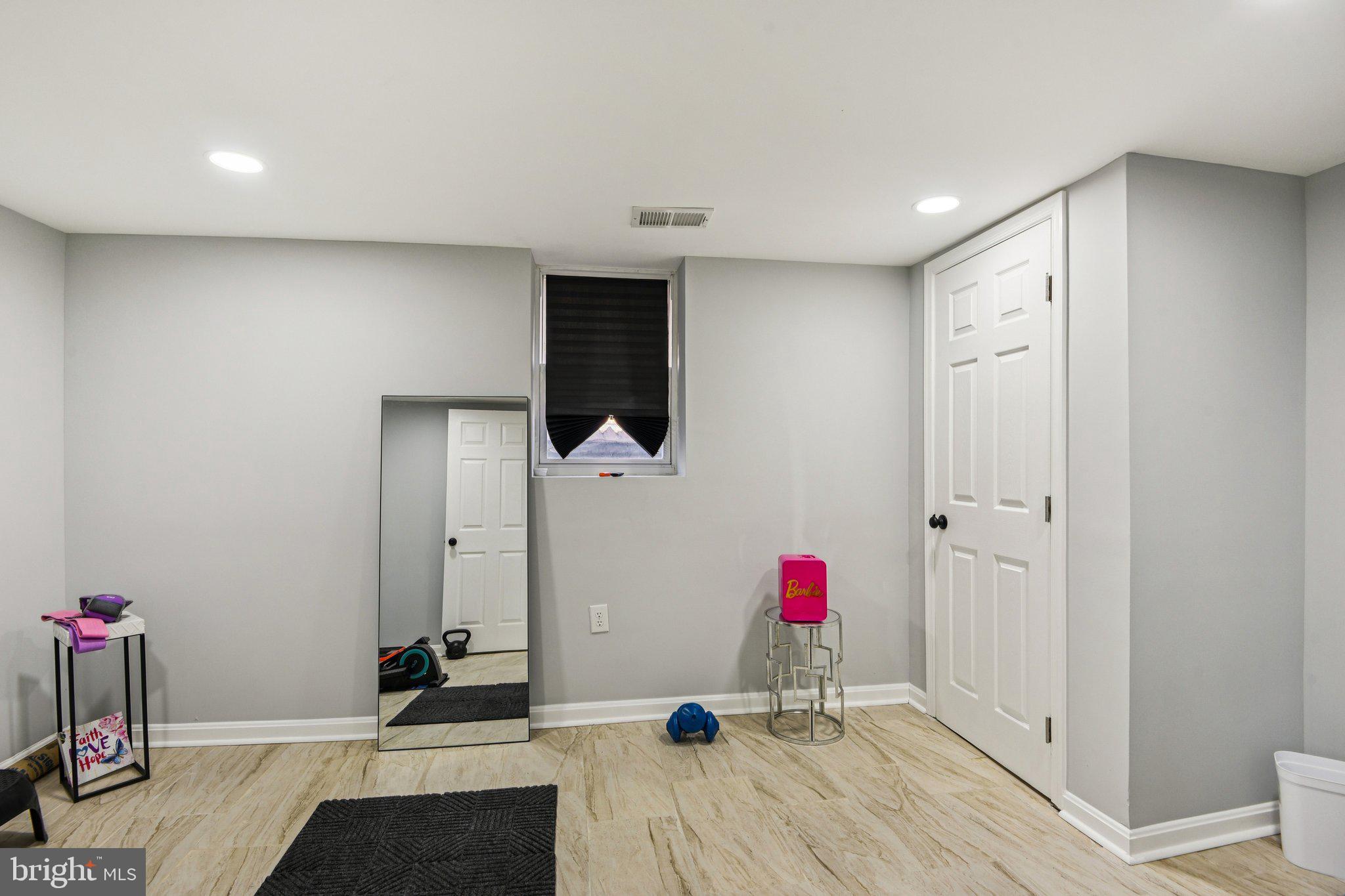 7004 Arion Road Baltimore, MD 21234 - Photo 25 of 43 a very nice looking room with a wooden floor and a potted plant