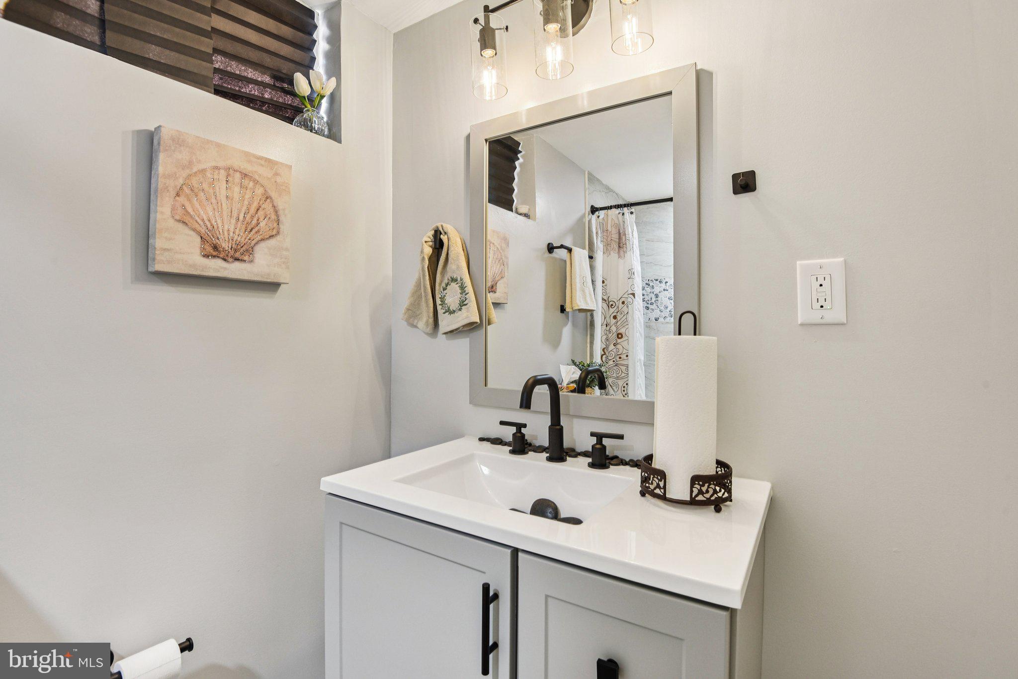 7004 Arion Road Baltimore, MD 21234 - Photo 28 of 43 a bathroom with a sink and a mirror