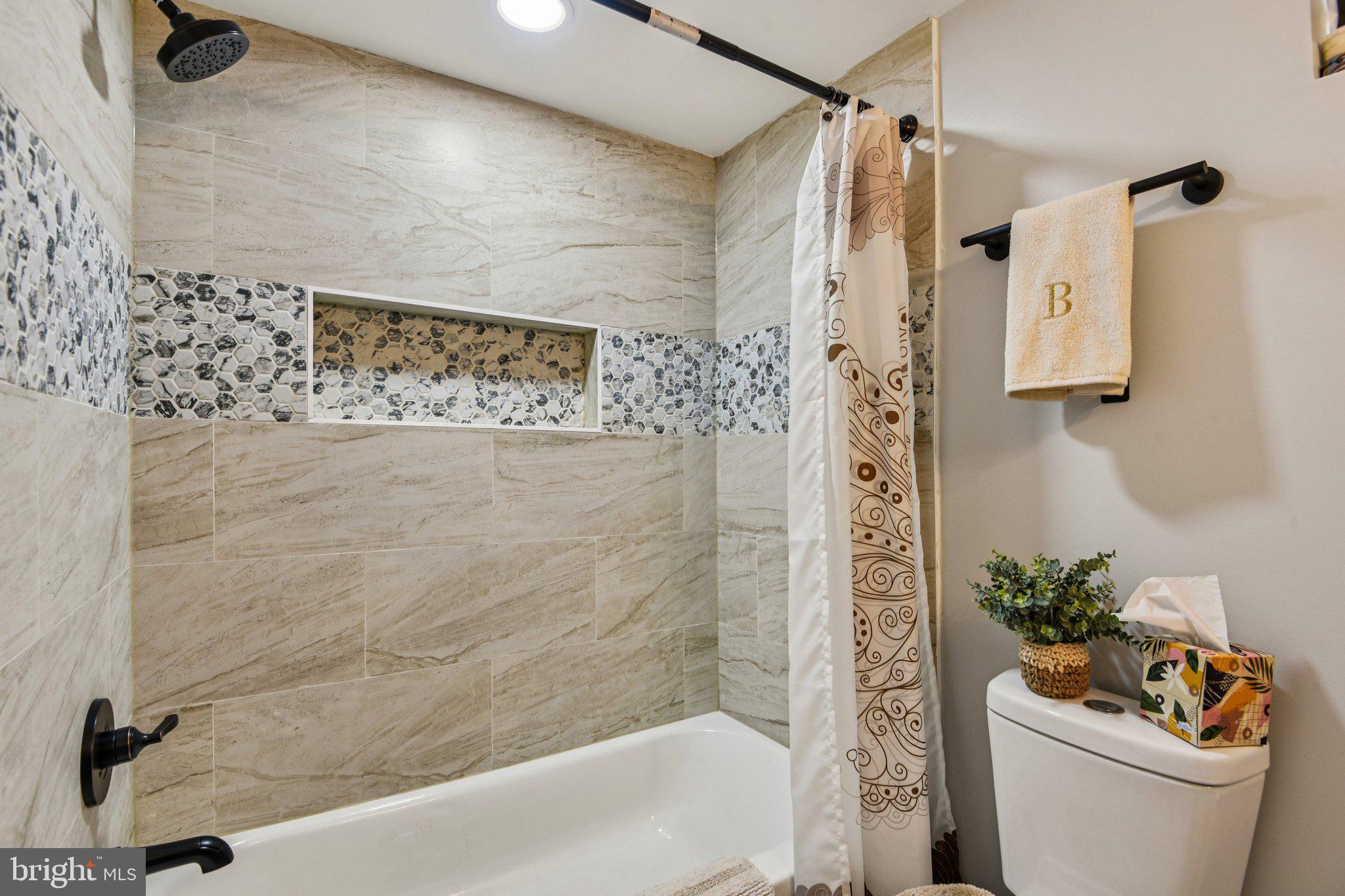 7004 Arion Road Baltimore, MD 21234 - Photo 29 of 43 a bathroom with a shower and a toilet