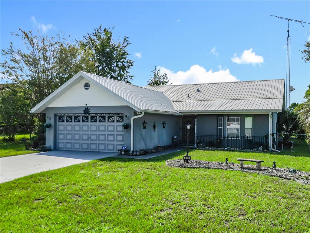 a view of a house with a yard and porch