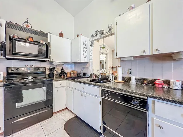a living room with furniture and a ceiling fan