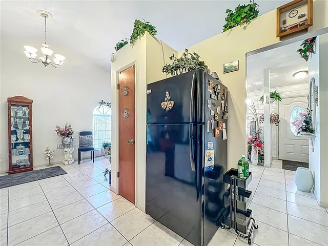 a view of a dining room with furniture and a chandelier