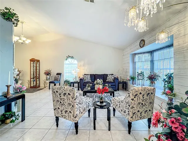 a living room with furniture a chandelier and a chandelier
