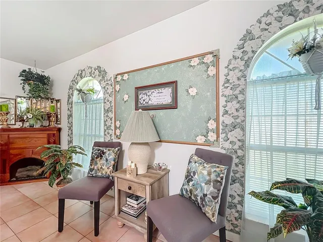 a view of a dining room with furniture and a chandelier