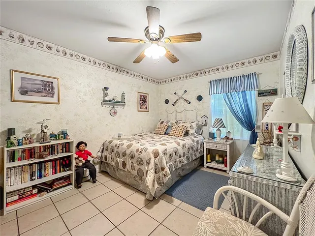 a bedroom with double bed and a chandelier