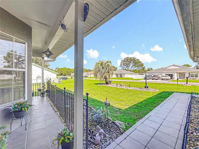 an aerial view of residential houses with outdoor space and street view