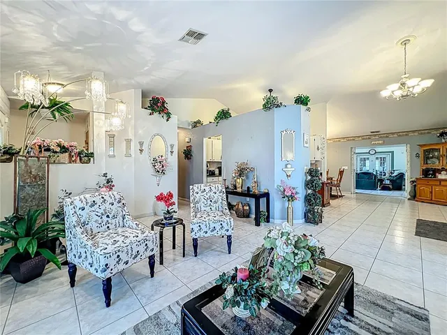 a lobby with furniture and a potted plant