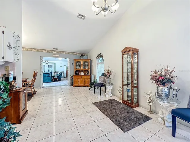 a view of a dining room with furniture and chandelier