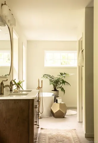 a dining room with furniture and a large window