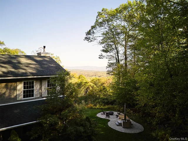 a backyard of a house with lots of green space and fountain