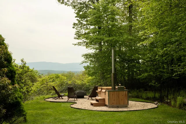 a view of a fountain with a tree in the background