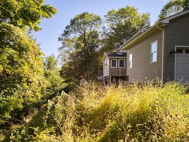 a house that has a tree in front of it