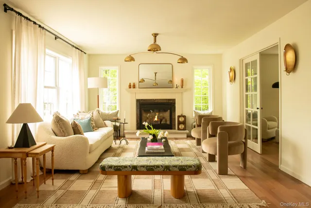 a living room with furniture fireplace and a table