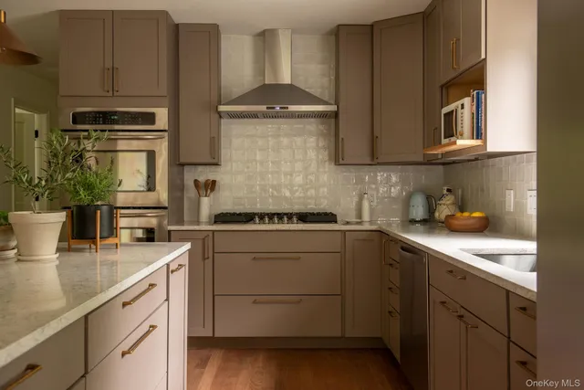 a kitchen with stainless steel appliances granite countertop a sink stove and cabinets