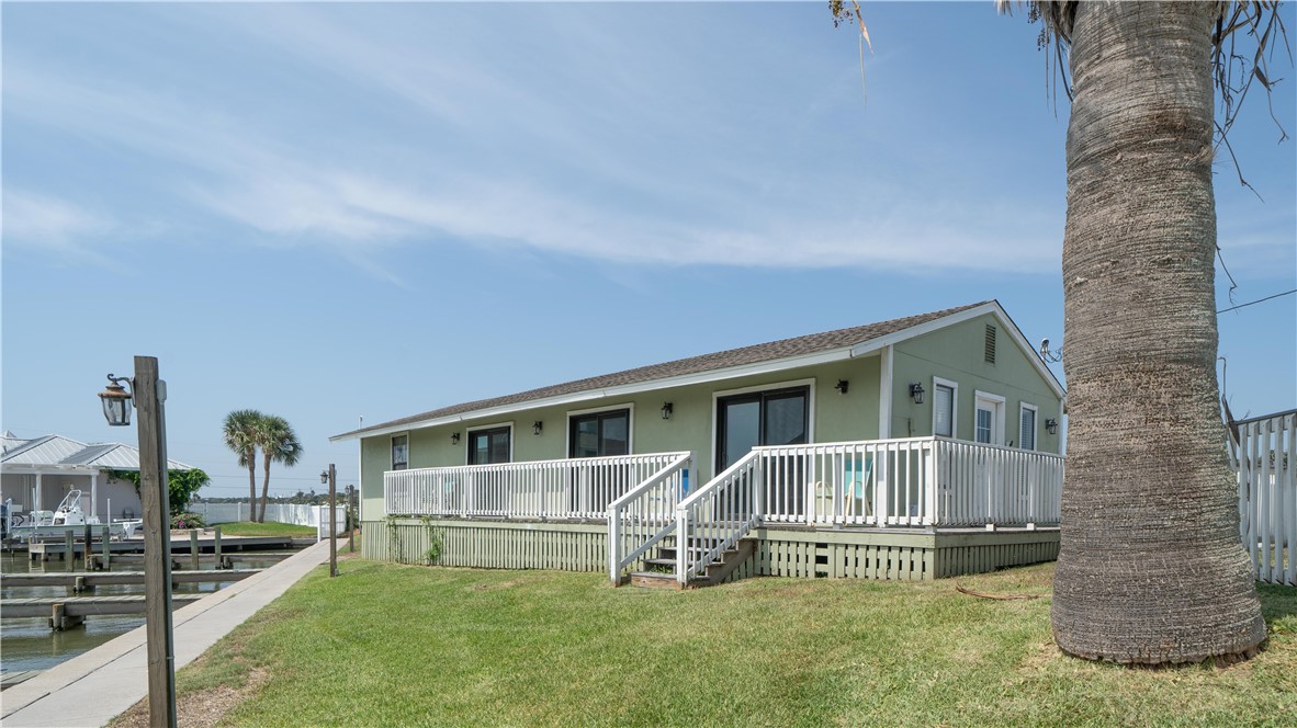 2290 North Fulton Beach Road Rockport, TX 78382 - Photo 4 of 26 a front view of a house with a yard