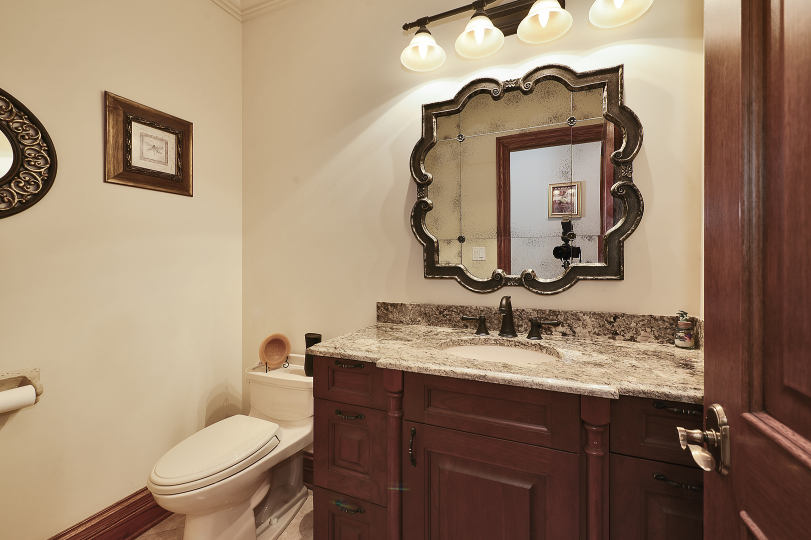 10 Carnoustie Lane Inverness, IL 60067 - Photo 16 of 44 a bathroom with a toilet sink vanity and mirror