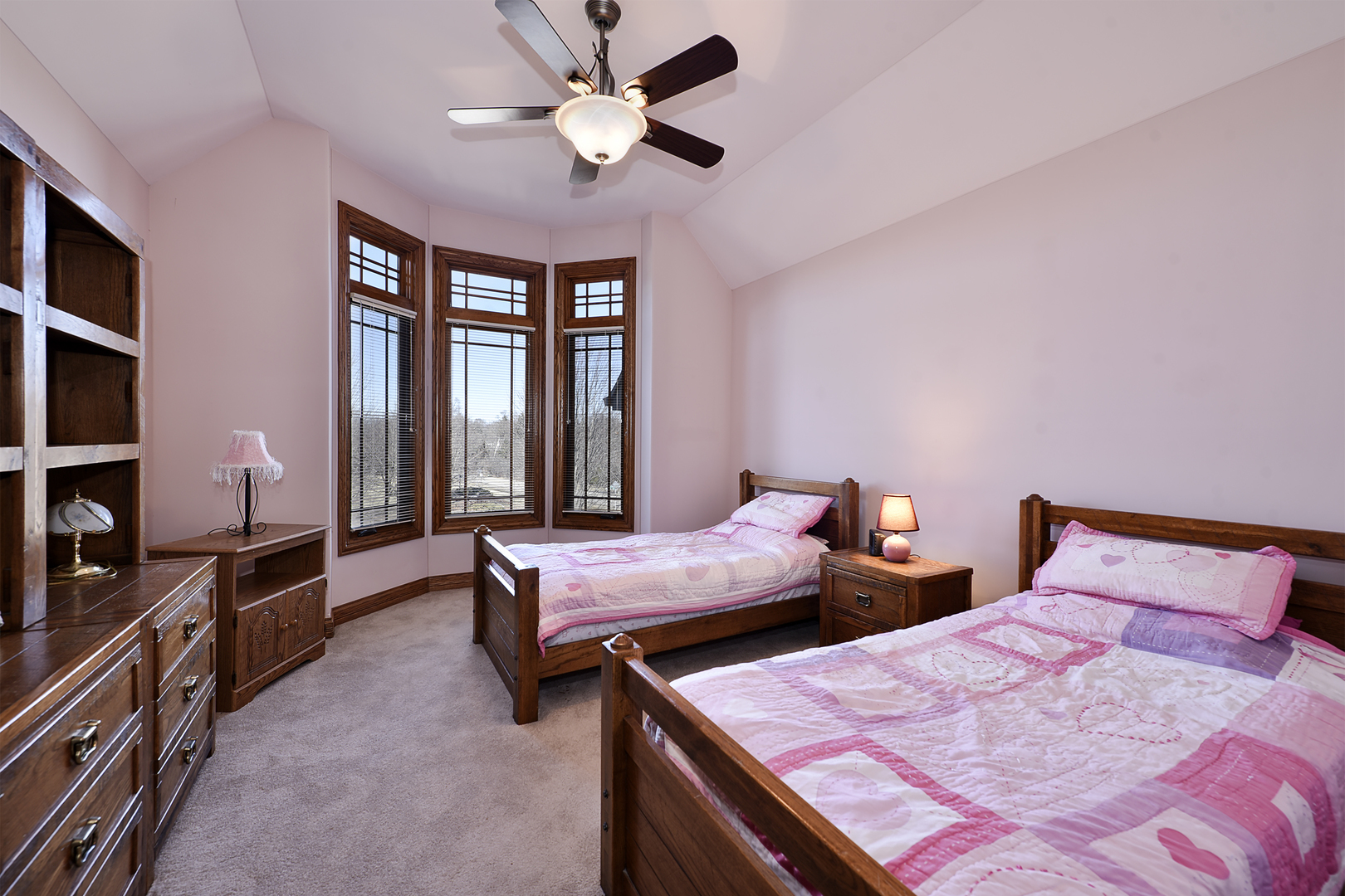 10 Carnoustie Lane Inverness, IL 60067 - Photo 22 of 44 a bedroom with two beds and a chandelier